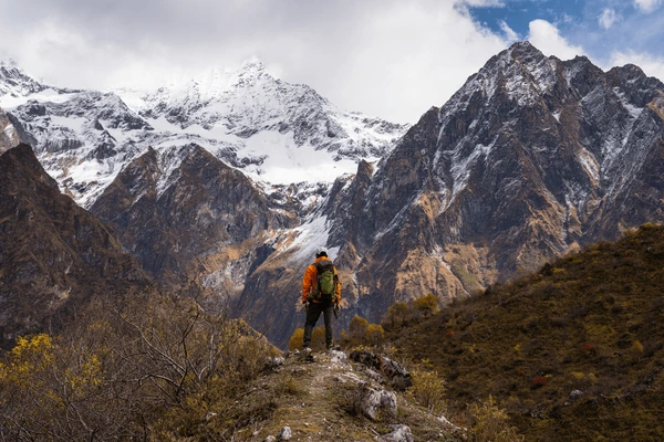 yong trekker standing on top hill manaslu